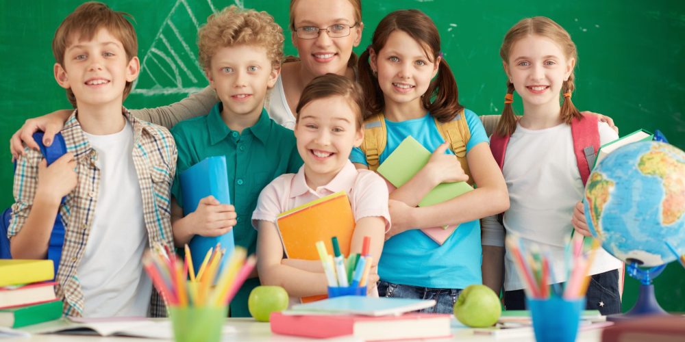 proud-teacher-with-her-elementary-students-min proud-teacher-with-her-elementary-students-min